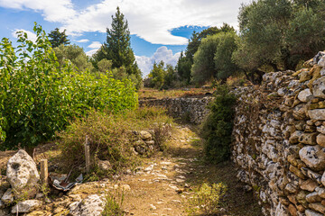 Footpath through fields with a stone wall on the island of Crete, Greece