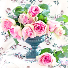 Close-up floral composition with a pink roses on a colorful background. Many beautiful fresh pink roses on a table.