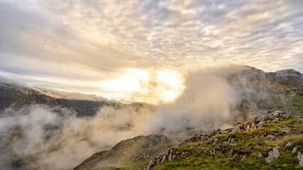 Rolling mist through morning sunshine in the mountains