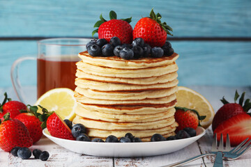 A stack if home-made pancakes with berry