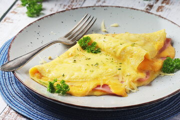 Omelette with ham and cheese on the plate
