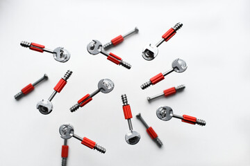 Minifix bolt set, with plastic shaft, eccentric. Background from screws and dowels. Collection of...