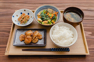 Japanese meal, butter garlic shrimp with fried vegetables and miso soup.