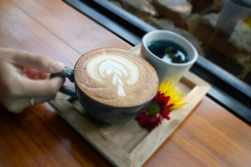 Latte coffee art cup in the garden