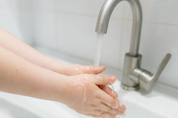 Washing hands in the bathroom. Real life in a pandemic, virus protection
