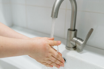 Washing hands in the bathroom. Real life in a pandemic, virus protection
