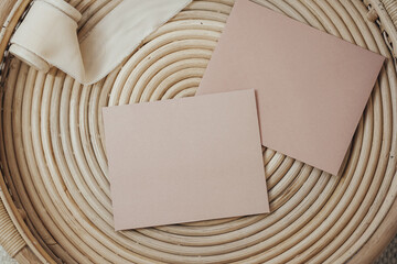 Two pink cards in boho interior on a wooden tray