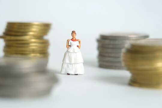 Wedding dress budget for bride, miniature people illustration concept. Woman standing between coin money stack. Image photo - Powered by Adobe