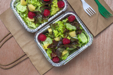 Healthy vegan take away salad in aluminum container