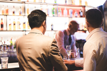 senior professional bartender making drink for business partner party relaxation, barkeeper working...
