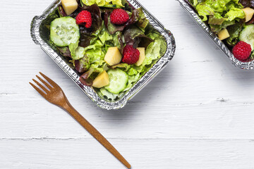 Healthy vegan take away salad in aluminum container