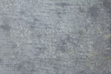 Stains of white paint on the texture of a concrete gray wall