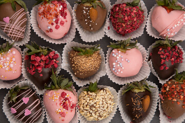 Variety of strawberries covered with chocolate, dark and white chocolate and nuts, on a isoleted background