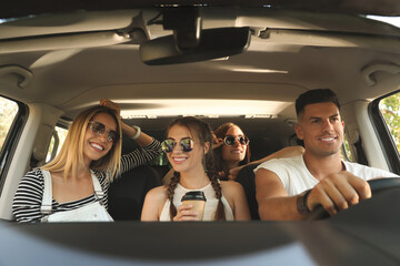 Happy friends together in car on road trip