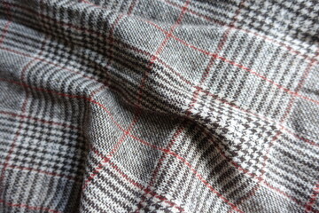 Crumpled red and grey Glen check woolen fabric