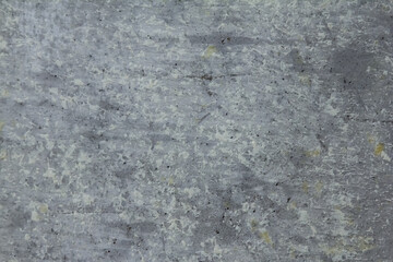 Textured concrete gray wall with paint spots and scratches