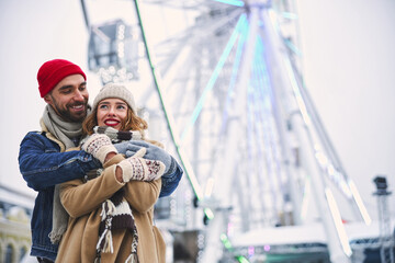 Happy young couple walking in city centre