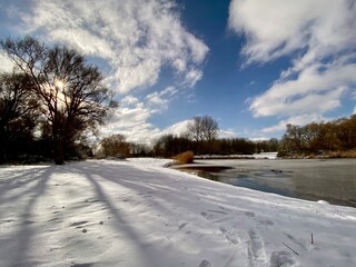 A snow covered field in Spijkenisse, dutch winter in The Netherlands, shadow from tree, beautiful landscape