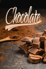 Pieces of dark chocolate and cocoa powder in the background, vertically with fixed Chocolate text.