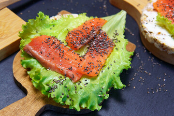 crispbread with salmon and cream cheese, salad lettuce, chia seeds