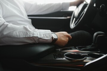 Close-up Of Person's Hand Changing Gear While Driving Car