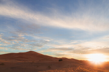 Fototapeta na wymiar A sunrise or sunset landscape view of the desert sand dunes of Erg Chebbi near the village of Merzouga, Morocco.