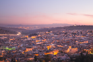 Sunrise or sunset cityscape skyline view of the old town of Fez, Morocco, the country's second largest city renowned for its historic Fes el Bali walled medina.