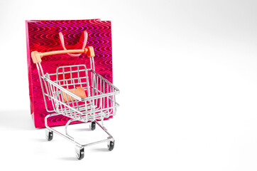 the concept of online Commerce shopping cart and package in red on white background with place for text