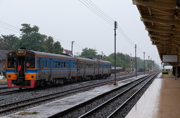 Diesel multiple units of the local train are leaving from the city station after receiving the green light.