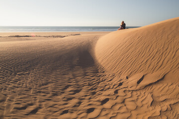 Fototapeta na wymiar Sandy dunes at the beach outside the seaside fishing village of Tafedna in Essaouira province, Morocco.