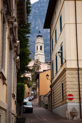 Street view of the tiny village with a church, a tower, stone houses and bridge in northern Italy in the alps close to the border with Austria and Switzerland. European architecture in Lombardy.