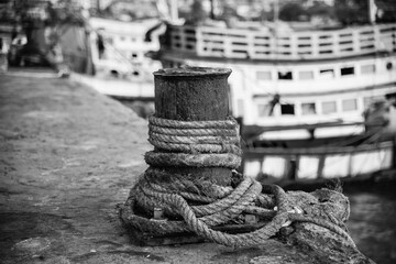 A steel pole for tying a fishing boat at the port of Si Racha District, Thailand. Photographed in...