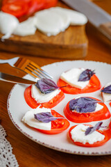 Traditional Italian Capreze salad - mozzarella, tomatoes, basil leaf, olive oil
