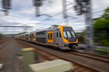 Sydney Train heading through Summerhill Station with background motion blur NSW Australia