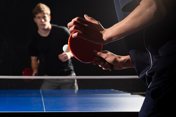Table tennis ping pong paddles and white ball on blue board - obrazy, fototapety, plakaty
