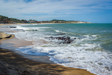 Sea with waves and dunes at Praia do Sagi, Baia Formosa, near Natal, Rio Grande do Norte State, Brazil on January 26, 2021.