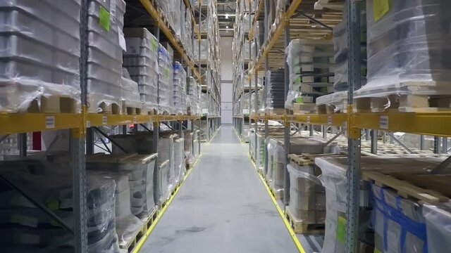 Camera moving through warehouse. racks with merchandise. rows shelves with cardboard boxes. storage room. Logistics center interior. concept nobody, goods, storehouse.