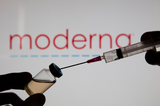 OXFORD, UK - February 2020: A Covid Vaccine Needle Against The Moderna Logo