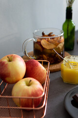 Composition of tea drinking. On a dark background, tea with dried fruits, apples, honey and chocolate. Antiviral kit. Side view 