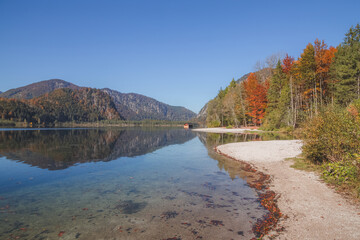 A lone boathouse on a calm autumn day at Lake Almsee in Upper Austria's part of the Salzkammergut in the Almtal valley.