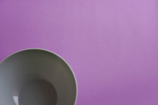 White Bowl With Purple Background Viewed From Above