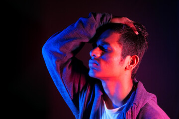 Close up of sad man covering face with hand.