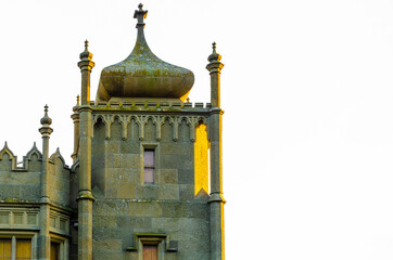 Obraz premium An old fortress with towers at sunset.
