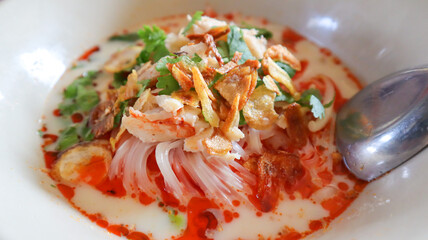 Spicy Tom Yum noodle soup with crab meat. Asian Thai food concept.
