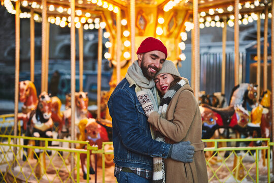 Happy young couple meeting at merry go round