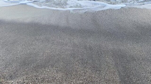 Waves breaking in the mediterranean sea in Nerja, M&aacute;laga while sunset