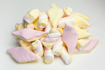 Fototapeta na wymiar heap of mixed marshmallow candy in yellow, pink, orange and white