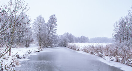 frozen river at a cold winter morning