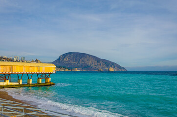 A vase made of stone for flowers on the street on the sidewalk.