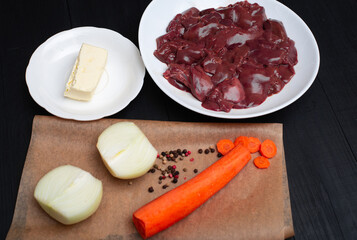 Raw chicken liver, carrots, onions, butter. Ingredients for making pate.